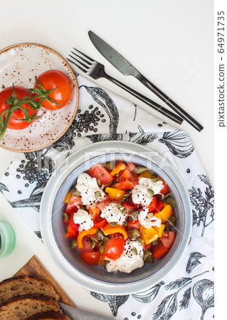 Healthy salad with grilled pepper, tomatoes, stracciatella, herbs and pumpkin seeds. Healthy eating concept. Healthy salad with grilled pepper, tomatoes, stracciatella, herbs and pumpkin seeds. Healthy eating concept. 64971735