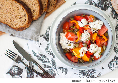 Healthy salad with grilled pepper, tomatoes, stracciatella, herbs and pumpkin seeds. Healthy eating concept. Healthy salad with grilled pepper, tomatoes, stracciatella, herbs and pumpkin seeds. Healthy eating concept. 64971736
