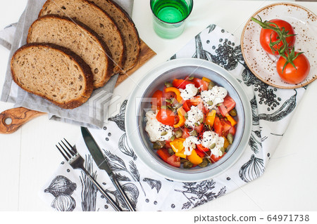 Healthy salad with grilled pepper, tomatoes, stracciatella, herbs and pumpkin seeds. Healthy eating concept. Healthy salad with grilled pepper, tomatoes, stracciatella, herbs and pumpkin seeds. Healthy eating concept. 64971738