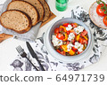 Healthy salad with grilled pepper, tomatoes, stracciatella, herbs and pumpkin seeds. Healthy eating concept. 64971739