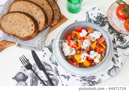 Healthy salad with grilled pepper, tomatoes, stracciatella, herbs and pumpkin seeds. Healthy eating concept. Healthy salad with grilled pepper, tomatoes, stracciatella, herbs and pumpkin seeds. Healthy eating concept. 64971739