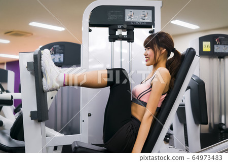 Young woman training in the gym Young woman training in the gym 64973483