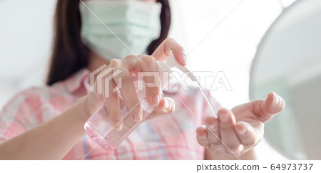 woman use hand sanitizer gel woman use hand sanitizer gel 64973737