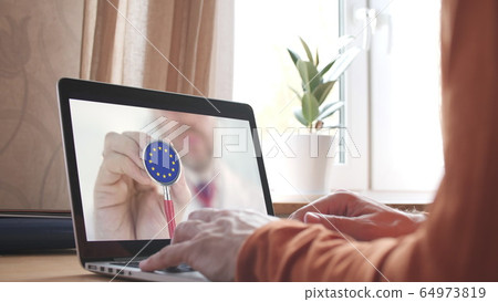 Doctor on the screen of computer and the stethoscope with flag of the EU. European telemedicine Doctor on the screen of computer and the stethoscope with flag of the EU. European telemedicine 64973819