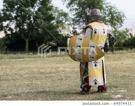 Medieval knight ready for battle Medieval reenactment with costumed and medieval armor 64974411