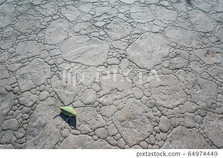 top view of stamped concrete pavement outdoor, boulders stones pattern, flooring exterior, decorative gray color and texture of cement paving 64974449
