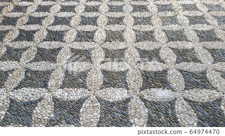 Cobbled pavement made of river rounded pebbles in Cordoba, Andalusia Cobbled pavement made of river rounded pebbles in Cordoba, Andalusia 64974470