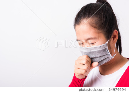 woman wearing face mask protective against woman wearing face mask protective against 64974694