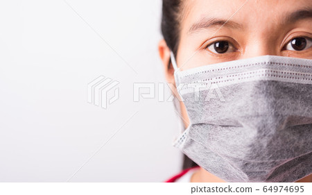 closeup woman wearing face mask protective against closeup woman wearing face mask protective against 64974695