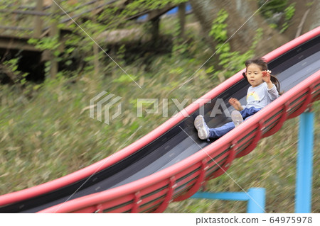 Infant playing on a slide (5 years old child) Infant playing on a slide (5 years old child) 64975978