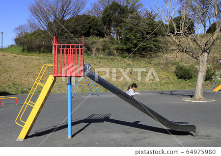 Infant playing on a slide (5 years old child) Infant playing on a slide (5 years old child) 64975980