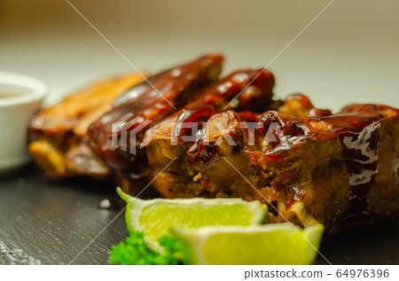 Pork ribs in a smoky flavour barbecue seasoning 64976396