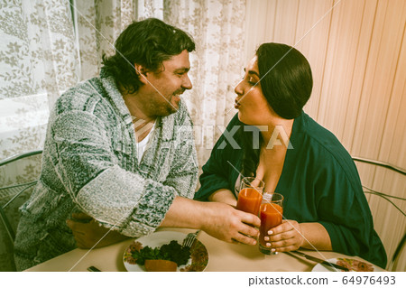 Overweight Man And Woman Clink Glasses Eating Healthy Food Overweight Man And Woman Clink Glasses Eating Healthy Food 64976493