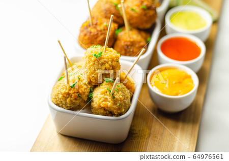 Various mini chicken kievs and sweet potato 64976561