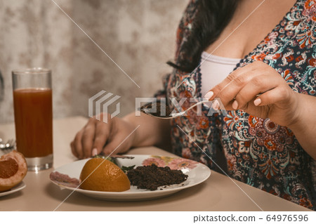 Overweight Woman Is On A Diet Eatting Healthy Food 64976596
