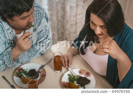 Plus Size Couple Dieting Or Healthy Eating At Home 64976598