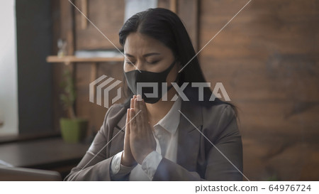 Praying business woman folded hands 64976724