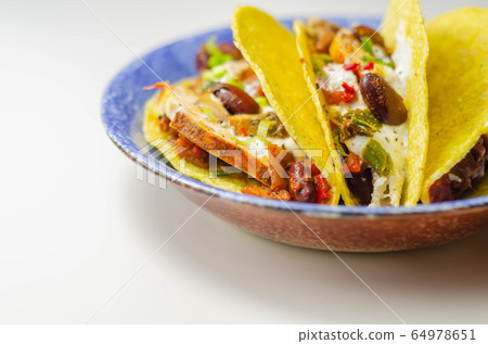 Mexican tacos shells with chicken and red kidney 64978651