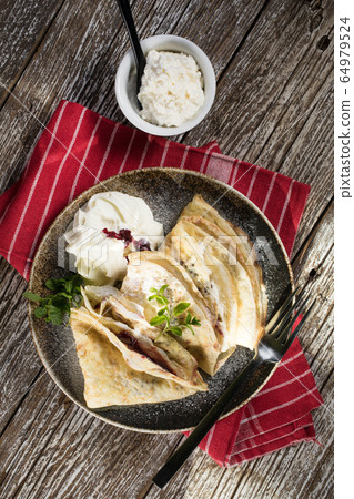 Crepes with ricotta cheese and blackcurrant jam. Crepes with ricotta cheese and blackcurrant jam. 64979524
