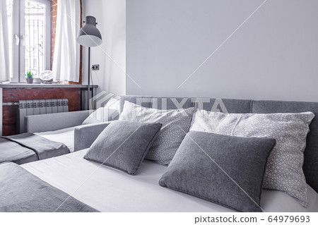 pillow on bed and nightstand cozy bedroom closeup pillow on bed and nightstand cozy bedroom closeup 64979693