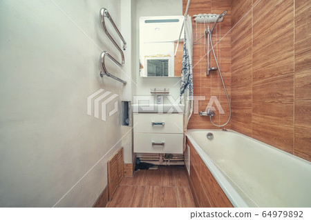 Small beige tile bathroom with bath tube Small beige tile bathroom with bath tube 64979892