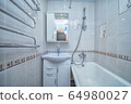 Small white tile bathroom with bath tube 64980027