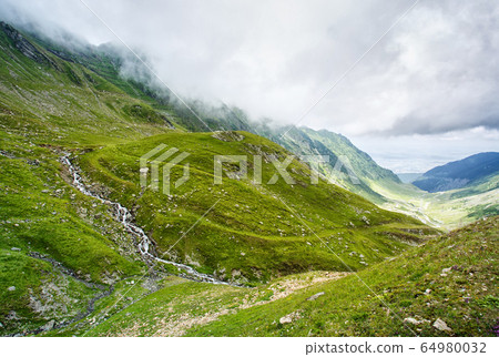 Summer landscape. Mountain stream. Clouds over the 64980032