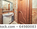 Small beige tile bathroom with sink and mirror 64980083