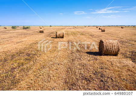 Autumn rural landscape. A haystack and a blue sky. European autumn. Autumn rural landscape. A haystack and a blue sky. European autumn. 64980107