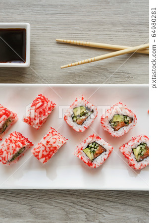 Top view of sushi roll. Salmon, cucumber, avocado Top view of sushi roll. Salmon, cucumber, avocado 64980281
