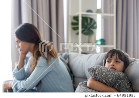 Angry sulky child and annoyed mother not talking after fight Angry sulky child and annoyed mother not talking after fight 64981985