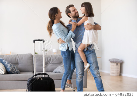 Happy father embracing kid and wife excited by family reunion Happy father embracing kid and wife excited by family reunion 64982025