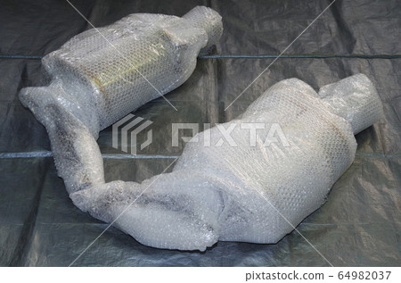 A muffler for passenger cars that has been carefully wrapped with bubble wrap to prevent damage during transportation. 64982037