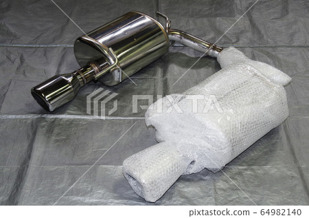 A muffler for passenger cars that has been carefully wrapped with bubble wrap to prevent damage during transportation. A muffler for passenger cars that has been carefully wrapped with bubble wrap to prevent damage during transportation. 64982140