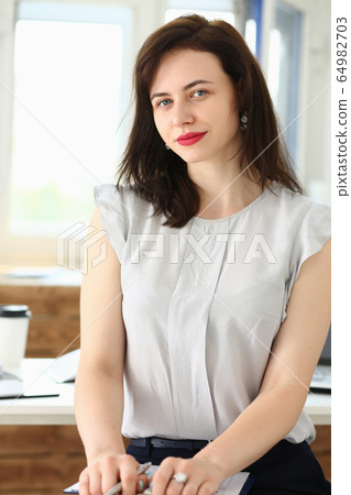 Beautiful smiling businesswoman portrait at workplace Beautiful smiling businesswoman portrait at workplace 64982703