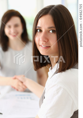 Beautiful girl at workplace look in camera Beautiful girl at workplace look in camera 64982705
