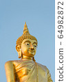 The standing buddha statue on blue sky, located in Chanthaburi, Thailand. 64982872