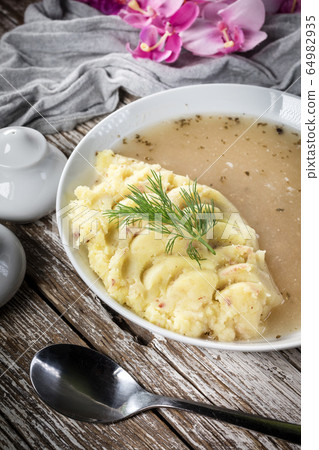 Pure white borscht served with mashed potatoes. Pure white borscht served with mashed potatoes. 64982935
