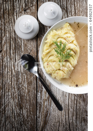 Pure white borscht served with mashed potatoes. Pure white borscht served with mashed potatoes. 64982937