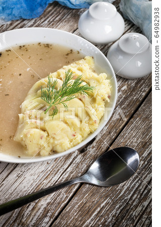 Pure white borscht served with mashed potatoes. Pure white borscht served with mashed potatoes. 64982938