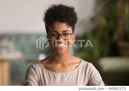 Headshot portrait of happy mixed race african girl wearing glasses Headshot portrait of happy mixed race african girl wearing glasses 64983173