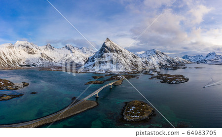 Fredvang Bridge and Volandstind Mountain in Winter at Sunset. Flakstadoya, Lofoten Islands Fredvang Bridge and Volandstind Mountain in Winter at Sunset. Flakstadoya, Lofoten Islands 64983705