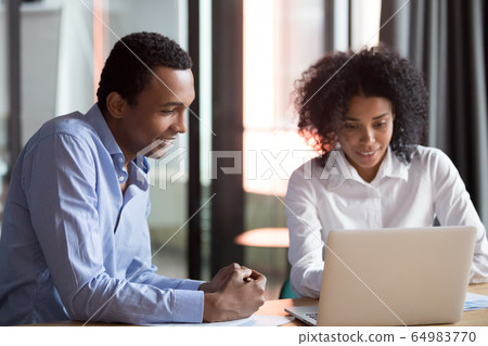Mixed-race mentor manager consulting african client teaching employee with laptop 64983770