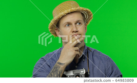 Portrait of tourist photographer thinking. Chroma key Portrait of tourist photographer thinking. Chroma key 64983809