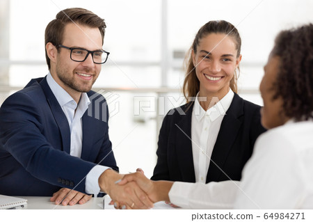 Happy hr handshaking hiring successful job candidate at business interview 64984271