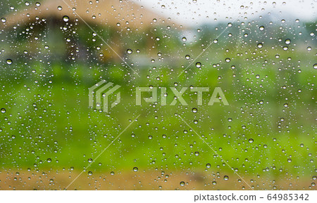 Drops of rain on the glass surface. Drops of rain on the glass surface. 64985342