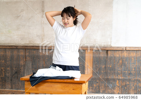 High school girl changing clothes in the classroom High school girl changing clothes in the classroom 64985968