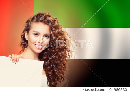 Happy woman student with white banner on the UAE Happy woman student with white banner on the UAE 64986880