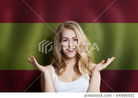 Surprised cute happy girl with Spain flag 64986881