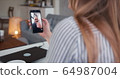 POV close-up young Caucasian woman talking to cheerful male friend on self isolation using smartphone video call online. 64987004